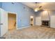 Spacious bedroom includes a stone fireplace, ceiling fan, and neutral carpeting at 171 Rockspray Rdg, Peachtree City, GA 30269