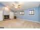 Spacious primary bedroom featuring a stone fireplace, ceiling fan and shuttered windows at 171 Rockspray Rdg, Peachtree City, GA 30269
