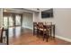 Well-lit dining area featuring hardwood floors, a dark wood table with four chairs, and an open floor plan at 171 Rockspray Rdg, Peachtree City, GA 30269