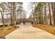 Charming home with a three-car garage, wooded landscaping, and long driveway at 171 Rockspray Rdg, Peachtree City, GA 30269