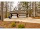 Charming home featuring a three-car garage surrounded by wooded landscaping at 171 Rockspray Rdg, Peachtree City, GA 30269