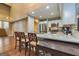 Bright kitchen boasts stainless steel appliances, granite countertops and a breakfast bar with seating on the hardwood flooring at 171 Rockspray Rdg, Peachtree City, GA 30269