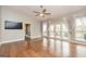 Open living room with hardwood floors, lots of natural light, a ceiling fan and access to the outdoor deck at 171 Rockspray Rdg, Peachtree City, GA 30269