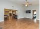 Open concept living room with hardwood floors, ceiling fan, tv, and views to kitchen and stairway at 171 Rockspray Rdg, Peachtree City, GA 30269