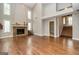 Open living room with hardwood floors, stone fireplace, and large windows at 171 Rockspray Rdg, Peachtree City, GA 30269