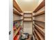 Walk-in pantry featuring wooden shelving and storage, with items stored and ready to be organized at 171 Rockspray Rdg, Peachtree City, GA 30269