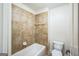 Bathroom featuring beige tile surround and shower, with white toilet and vanity with storage at 3393 Willow Glen Trl, Suwanee, GA 30024