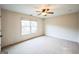 Bright bedroom features neutral carpet, ceiling fan, and a window that offers lots of natural light at 3393 Willow Glen Trl, Suwanee, GA 30024