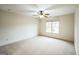 The bedroom is spacious with neutral carpet, a ceiling fan, and a window that offers great natural light at 3393 Willow Glen Trl, Suwanee, GA 30024