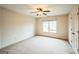 The bedroom is spacious with neutral carpet, a ceiling fan, and large windows offering great natural light at 3393 Willow Glen Trl, Suwanee, GA 30024