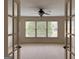 View of a sunlit bedroom with french doors and plush carpet at 3393 Willow Glen Trl, Suwanee, GA 30024