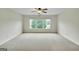Spacious bedroom with neutral carpet, ceiling fan, and a triple window offering great natural light at 3393 Willow Glen Trl, Suwanee, GA 30024