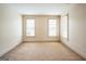 Bright bedroom with plush carpeting, neutral walls, and large windows with blinds at 3393 Willow Glen Trl, Suwanee, GA 30024
