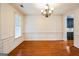 Spacious dining room with hardwood floors, detailed molding, and decorative chandelier at 3393 Willow Glen Trl, Suwanee, GA 30024