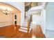 Elegant foyer with hardwood floors, staircase, and an arched doorway leading to a dining room at 3393 Willow Glen Trl, Suwanee, GA 30024