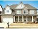 Beautiful two-story brick home with a well-manicured front yard and a charming covered porch at 3393 Willow Glen Trl, Suwanee, GA 30024