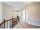 Hallway with carpeted staircase and decorative railing at 3393 Willow Glen Trl, Suwanee, GA 30024