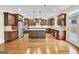 Expansive kitchen with stainless steel appliances, island, granite countertops, and hardwood flooring at 3393 Willow Glen Trl, Suwanee, GA 30024