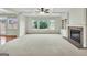 Bright living room with coffered ceiling, fireplace, built-ins, and large windows overlooking the backyard at 3393 Willow Glen Trl, Suwanee, GA 30024