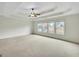 Spacious main bedroom features plush carpet, ceiling fan, and large windows at 3393 Willow Glen Trl, Suwanee, GA 30024