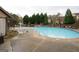 Community swimming pool with sundeck, tables, chairs and umbrellas at 3393 Willow Glen Trl, Suwanee, GA 30024