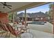 Covered back patio overlooking the in-ground pool, outdoor seating, and lush landscape at 3530 Highway 81 W, Hampton, GA 30228