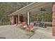 Covered outdoor patio with red brick accents, ceiling fans, and lounge seating at 3530 Highway 81 W, Hampton, GA 30228