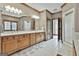 This bathroom offers a dual sink vanity, a large mirror, and bright, white tile floors at 3530 Highway 81 W, Hampton, GA 30228