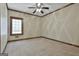 This carpeted bedroom features a ceiling fan and a window that provides plenty of natural light at 3530 Highway 81 W, Hampton, GA 30228