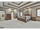 This bedroom has a tray ceiling, a four poster bed, and an ensuite bathroom at 3530 Highway 81 W, Hampton, GA 30228