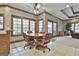 Charming breakfast nook with a round wooden table, leather chairs, and natural light from large windows at 3530 Highway 81 W, Hampton, GA 30228