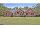 Lovely single-story brick home on a spacious lot with a well-maintained lawn and mature trees in the background at 3530 Highway 81 W, Hampton, GA 30228