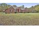 Charming one-story brick house with a well-manicured lawn and black shutters on the windows at 3530 Highway 81 W, Hampton, GA 30228