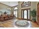 Elegant foyer boasts hardwood floors, a decorative rug, a dining room view, and a stained glass front door at 3530 Highway 81 W, Hampton, GA 30228