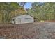 Spacious garage with a car port and a roll up door on a tree covered lot at 3530 Highway 81 W, Hampton, GA 30228