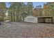 Spacious garage with a car port and a roll up door on a tree covered lot at 3530 Highway 81 W, Hampton, GA 30228