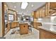 Modern kitchen with stainless appliances, wooden cabinets and central island leading to an adjacent living room at 3530 Highway 81 W, Hampton, GA 30228