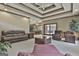 Expansive living room with a fireplace, coffee table, plush seating, and coffered ceilings at 3530 Highway 81 W, Hampton, GA 30228
