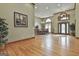 Open-concept living room with hardwood floors connecting to the dining room and foyer at 3530 Highway 81 W, Hampton, GA 30228