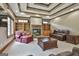 Inviting living room with a stone fireplace, built-in shelves, comfortable seating, and a coffered ceiling at 3530 Highway 81 W, Hampton, GA 30228