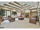Spacious living room features a coffered ceiling, fireplace, built-in bookshelves, and comfortable seating at 3530 Highway 81 W, Hampton, GA 30228