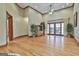 Spacious living room with tall ceilings, hardwood floors, a ceiling fan, and French doors leading to the outside at 3530 Highway 81 W, Hampton, GA 30228