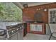 This outdoor kitchen features a built-in grill, stainless steel storage, and sink for easy entertaining at 3530 Highway 81 W, Hampton, GA 30228