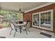 Covered outdoor patio with grill, seating, and access to the outdoor kitchen at 3530 Highway 81 W, Hampton, GA 30228