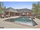Gorgeous in-ground pool and back patio with red brick accents and stone waterfall feature at 3530 Highway 81 W, Hampton, GA 30228