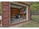 View of the pool house with brick exterior, storage space, and pool equipment at 3530 Highway 81 W, Hampton, GA 30228