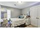 Bedroom with neutral décor, vanity, and a large window at 5163 Holly Springs Dr, Douglasville, GA 30135