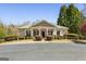 Charming clubhouse with a welcoming entrance, manicured landscaping, and classic architectural details at 5163 Holly Springs Dr, Douglasville, GA 30135