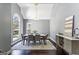 Bright dining room boasts a modern chandelier, gray walls, and an arched window at 5163 Holly Springs Dr, Douglasville, GA 30135