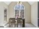 Light-filled dining room with arched window and wood table at 5163 Holly Springs Dr, Douglasville, GA 30135